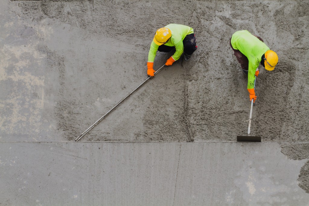 Construction workers placing cement