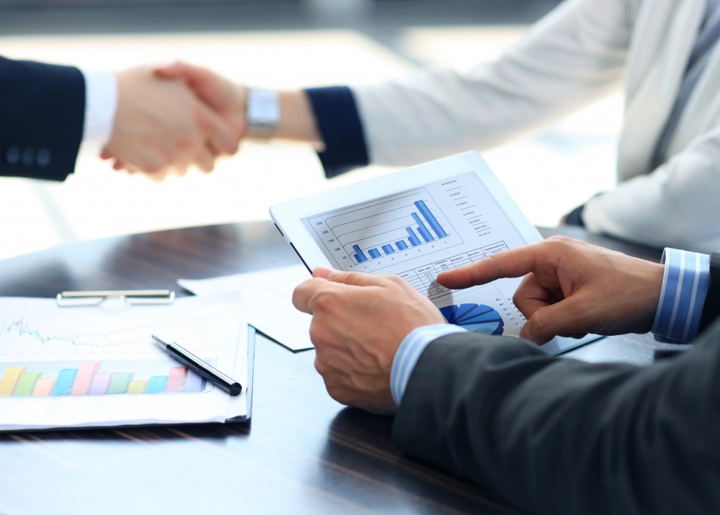 shaking hands and man using tablet