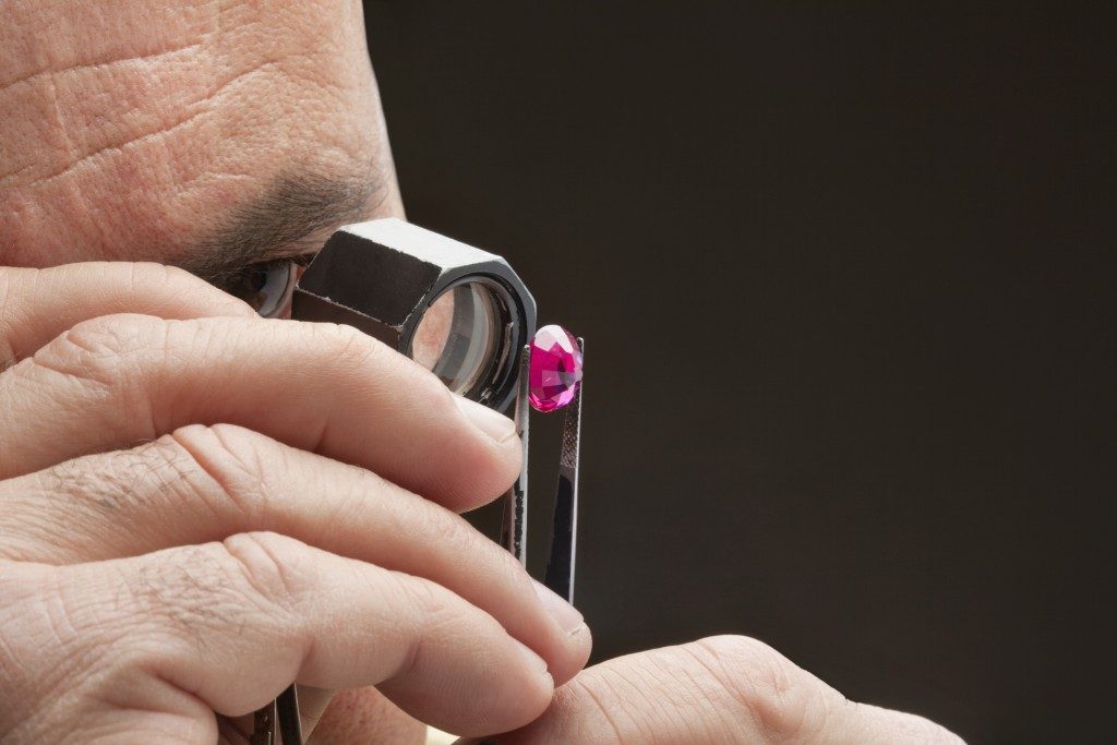 Jeweler inspecting a ruby