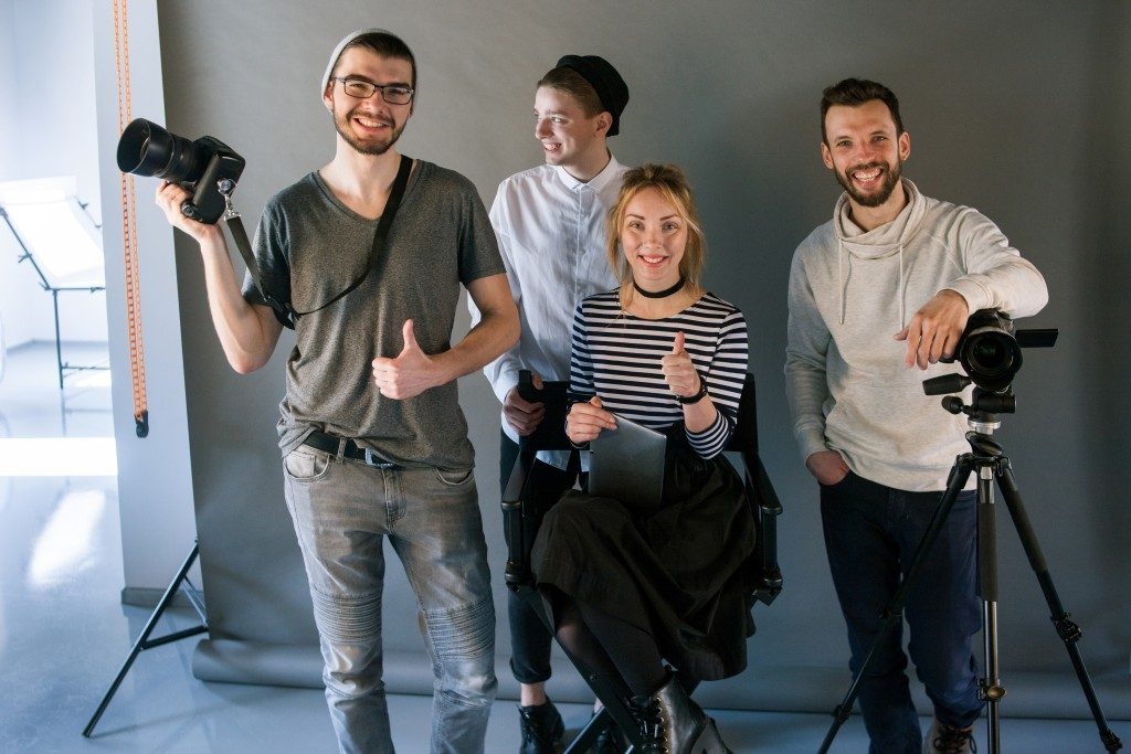 photographers posing in a photobooth
