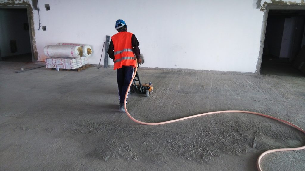 Worker dragging a air hose