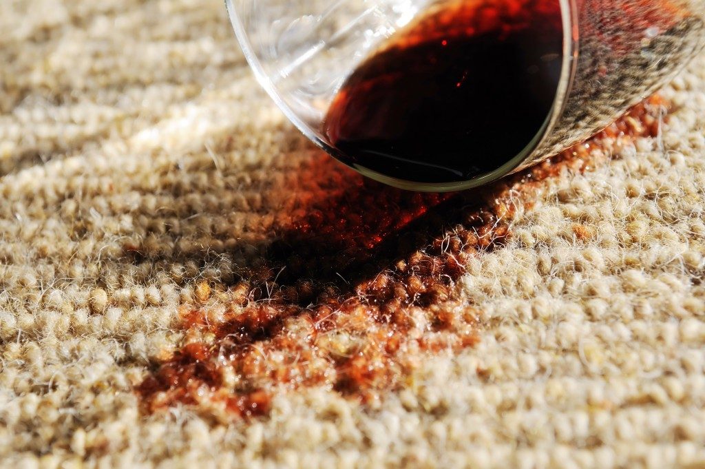 A glass of red wine spilt on a pure wool carpet