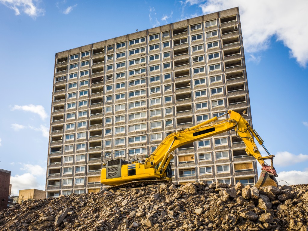 yellow excavator being used in the ongoing building contruction