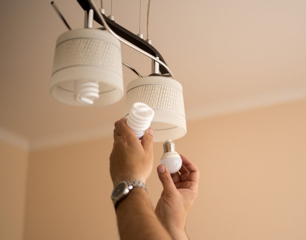 person installing led light bulbs