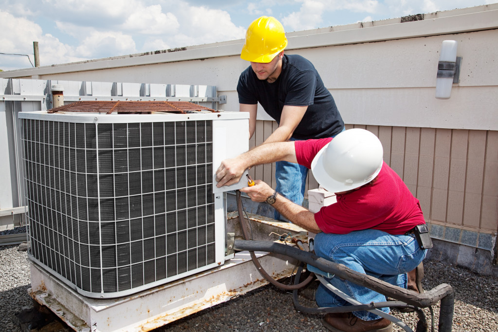 Professionals working on a commercial HVAC unit.