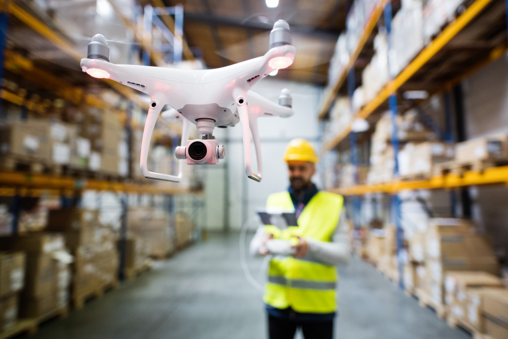 man with drone in warehouse