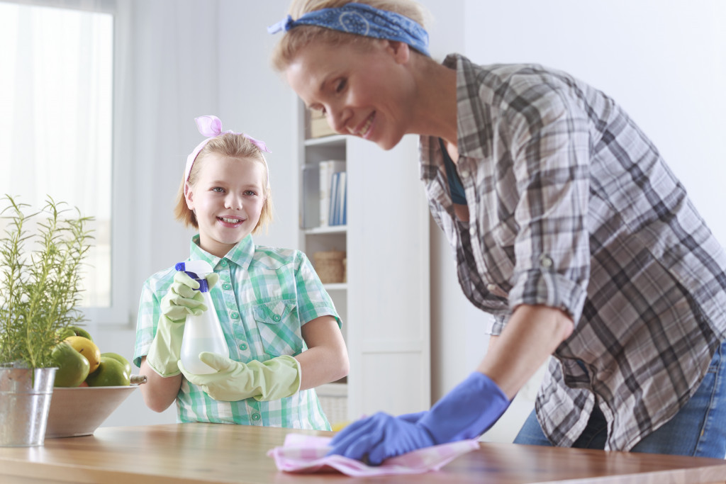 mother and daughter cleaning together