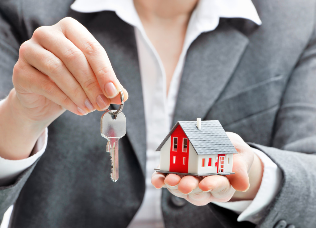 woman holding a house key